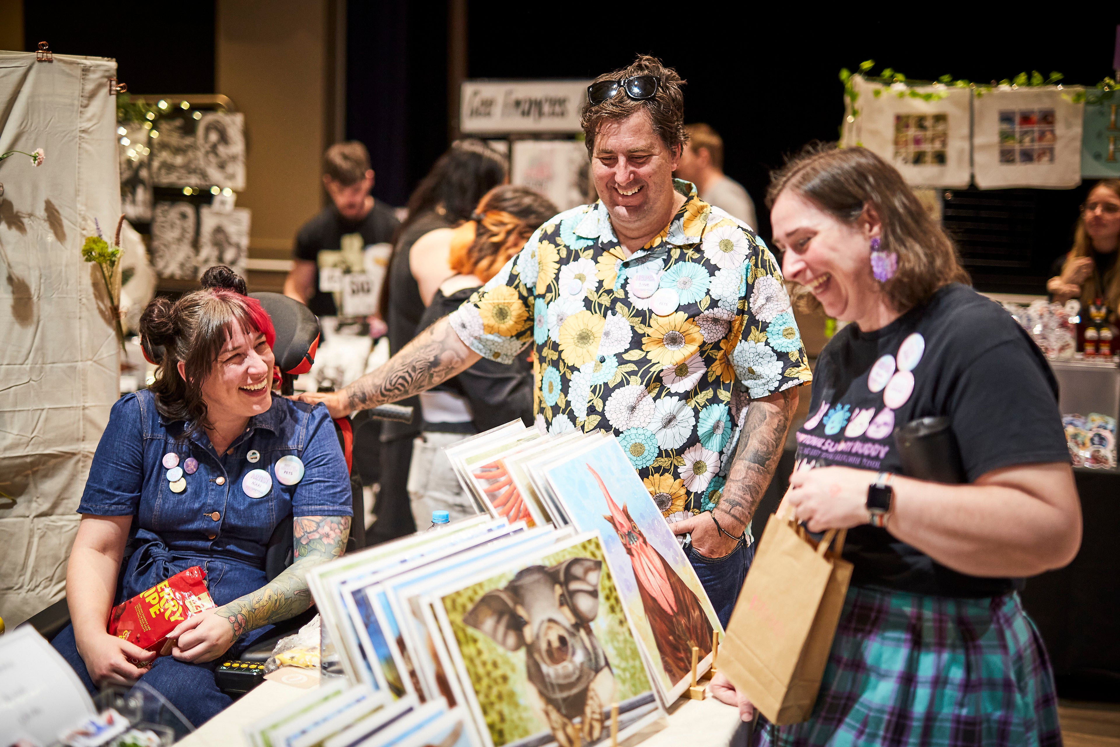 People interacting with vintage-style greeting cards featuring animals at the market.