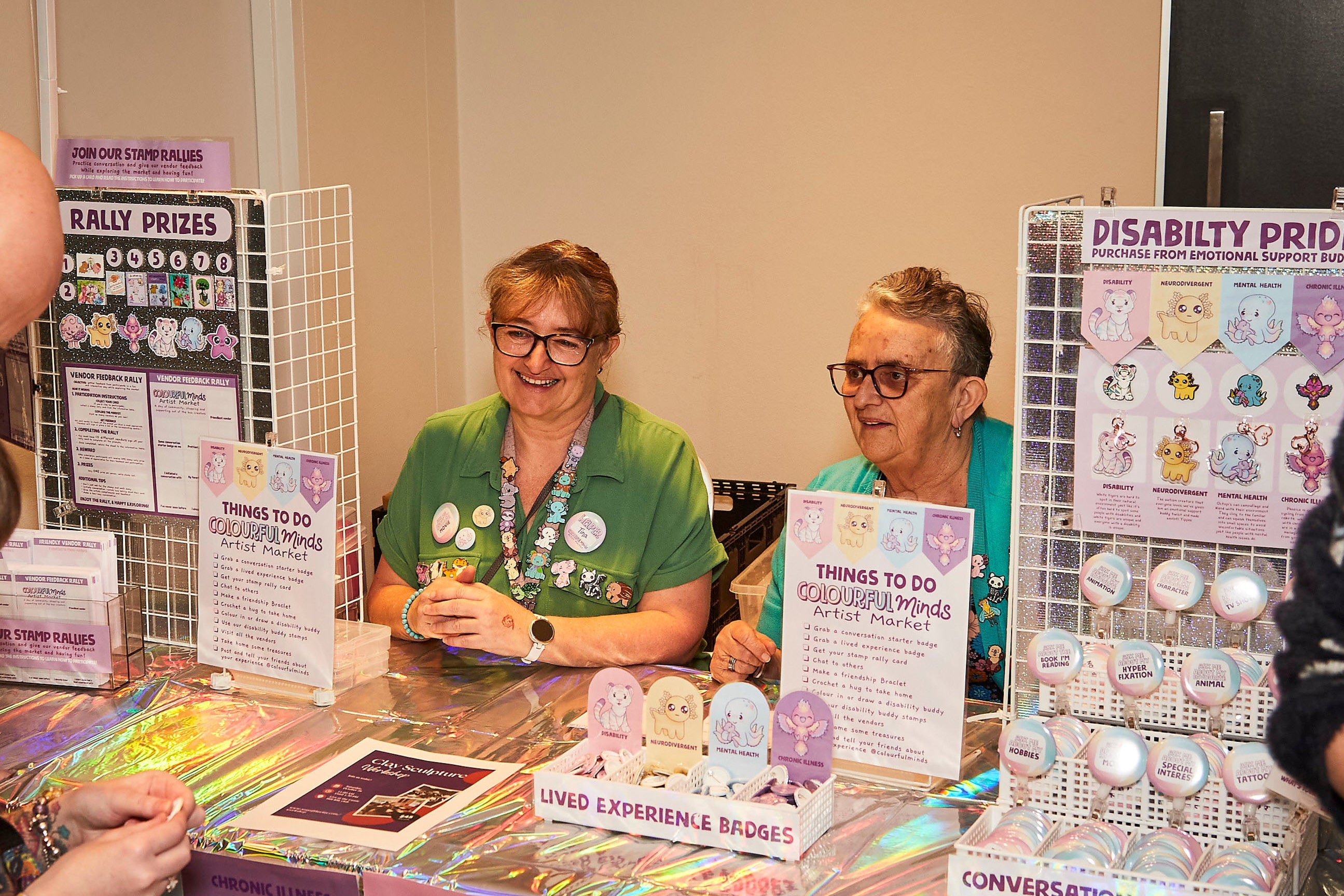 People interacting with a display of colorful cards and information at an event.